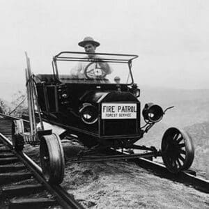 Fire Patrol Rides Steel wheeled car over Railroad Tracks - Art Print