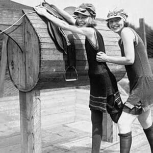 Girl is Helped by Friend to Mount a wooden Polo Dummy Horse - Art Print