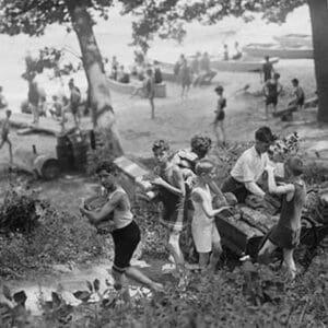 Group of Boys carry loaves of bread from wagons near beach front in woods. - Art Print